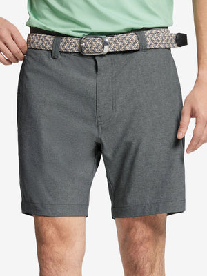 Front view of youth wearing dark grey Heather Performance Golf Shorts, showing fit and style