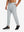 Front lower body view of model wearing soft sweatpants with 4 zipper pockets in light grey heather