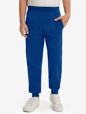 Model wearing klein blue fleece stretch water resistant boys joggers, front view showing lower body and pants.