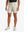 LIGHT KHAKI 4-way Stretch Performance Solid Shorts, golfer front lower body with club, 7 Inch view
