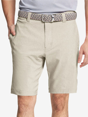Front view of youth wearing cream Heather Performance Golf Shorts, showing fit and style