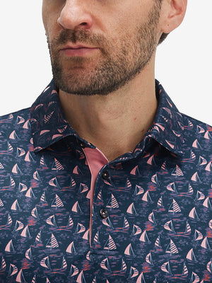 Front view from nose to chest of model wearing the navy sailboat 4 way stretch print collared polo shirt, showcasing the upper fit