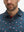 Front view from nose to chest of model wearing the american flag eagle 4 way stretch print collared polo shirt, showcasing the upper fit