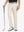 LIGHT KHAKI Water Resistant Everyday Pants front view, model's lower body holding a golf club