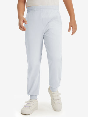 Model wearing misty grey fleece stretch water resistant boys joggers, front view showing lower body and pants.