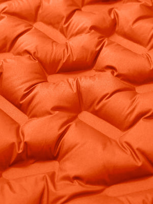 Fabric close-up showing the material of orange boys full-zip fleece-lined puffer vest.