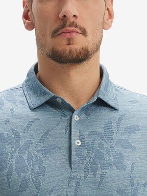 Front view from nose to chest of model wearing blue flower breathable jacquard pattern 3-button golf polo
