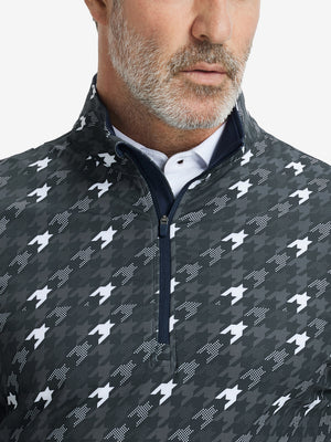 Close-up from nose to chest, showing zipper collar detail and fabric pattern of the grey houndstooth pullover.