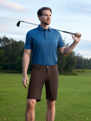 Model holding golf club wearing 4-way stretch performance solid shorts in clean dark brown