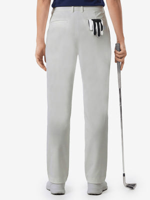 Back lower body shot of model wearing silver grey women's regular fit stretchy golf pants