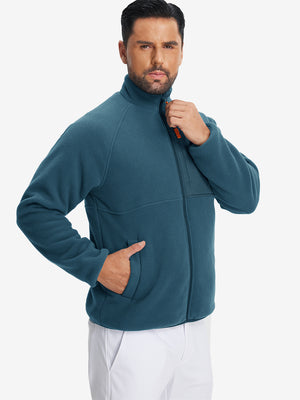 Model wearing the reversible fleece jacket with 5 pockets in dark blue, casually posing with one hand in the pocket for a stylish, practical look.