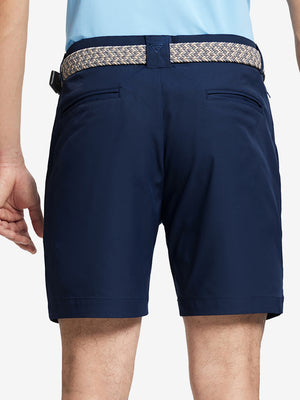 Back waist to knee view of navy water resistant golf 7 inch shorts, flexible performance fit.