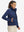 Model wearing women's lightweight fleece-lined puffer jacket, navy, front upper-body look.