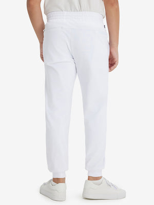 Model's lower body from the back, wearing white fleece stretch water resistant boys joggers.