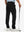 Back lower-body view of lightweight moisture wicking dress pants, model with golf club in black.
