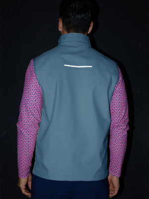 Model back half-body shot showcasing sleeveless softshell fleece outdoor vests with 6 pockets in misty blue
