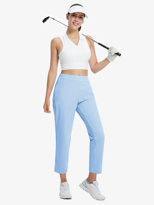 Full-body front view wearing golf hat and holding club in LIGHT BLUE Women's 7/8 Ankle Golf Track Pants.