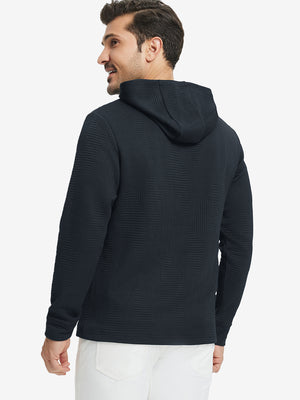 Back view of model wearing texture solid hoodies pullover showing fit and hood detail, navy.