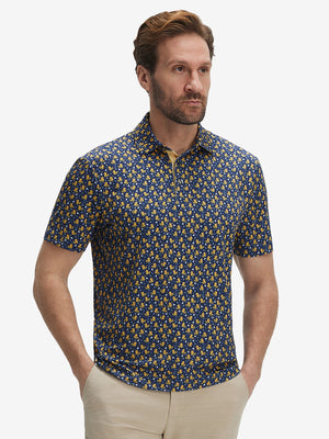 Front half-body shot of model wearing the yellow duck 4 way stretch print collared polo shirt for a casual sporty look