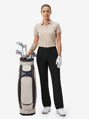 Front full body shot of model with golf gear wearing black women's regular fit stretchy golf pants