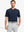 Front half-body view holding a golf club in Everyday Collarless Jersey Shirt in NAVY.