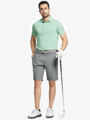 Full body front view of model wearing LIGHT GREY 9 Inch Heather Performance Golf Shorts, holding a golf club