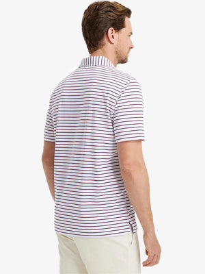 Model holding golf club in WHITE/NAVY STRIPE Polo — classic sporty look
