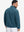 Back view of the model in the reversible fleece jacket with 5 pockets in dark blue.