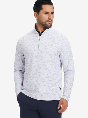 Front upper body view of model standing in brown grey camo full print quarter zip pullover, relaxed look.