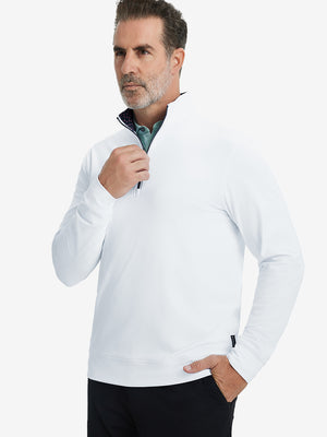 Front upper body view of model wearing lightweight golf quarter zip pullover in white, relaxed fit.
