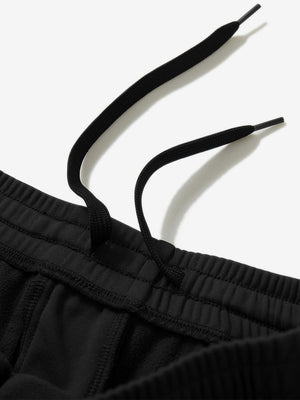 Close-up of the waistband with drawstring detail of black fleece stretch water resistant boys joggers.