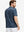 Back half-body of model in dark blue plant stretch printed collarless henley golf shirts