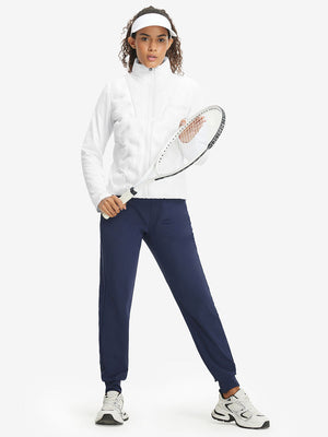 Model holding a tennis racket, wearing white women's lightweight fleece-lined puffer jacket.