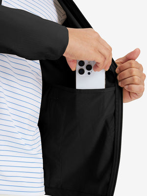 Hand placing iPhone into inner pocket of lightweight water-resistant outerwear jacket in black