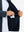 Close-up of winter thermal outdoor water resistant fleece jacket pocket holding a phone, practical detail in navy