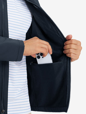 Close-up of winter thermal outdoor water resistant fleece jacket pocket holding a phone, practical detail in navy
