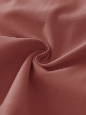 Fabric detail of 4-way stretch performance solid shorts with flexible feel in cranberry