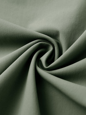 Close-up of quick dry casual dress pants fabric in olive green, smooth texture with breathable finish