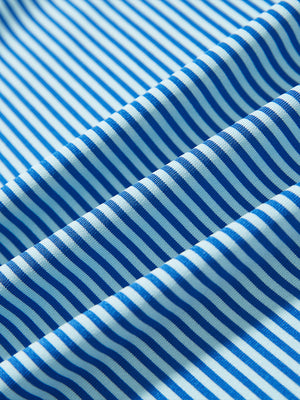 Close-up of aqua stripe performance cooling polo - youth fabric texture.