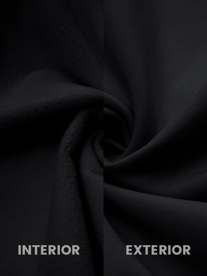 Close-up of black softshell jacket showing water resistant outer shell and smooth inner lining.