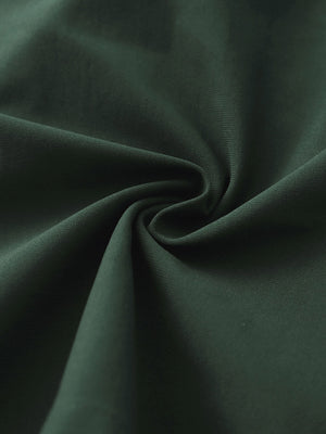 Close-up fabric detail of 4-way stretch performance solid shorts, smooth texture with flexible olive green feel