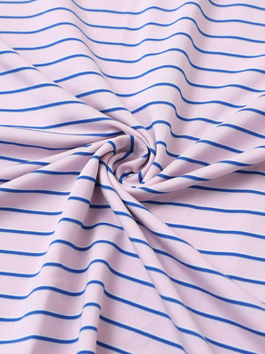 Close-up fabric view of youth performance golf polos, smooth texture with breathable light pink/cobalt stripe finish