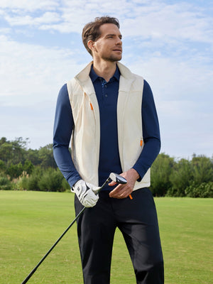 Model holding a golf club, upper body shot from head to knees, wearing Beige Windproof Fleece Reversible Golf Vest.