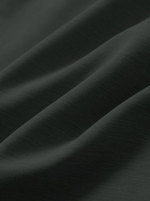 Close-up texture of dark charcoal straight fit lightweight dress golf pants fabric showing detailed lightweight weave and material.