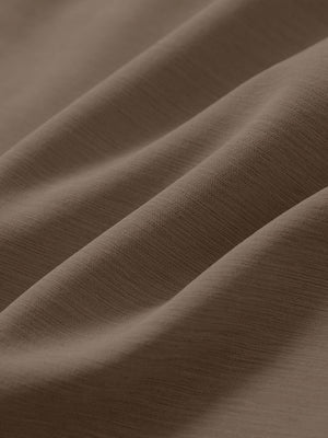 Close-up texture of tobacco brown straight fit lightweight dress golf pants fabric showing detailed lightweight weave and material.