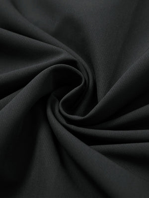 Mock neck quarter button golf pullover, detailed fabric close-up in black showing soft texture and fine knit finish