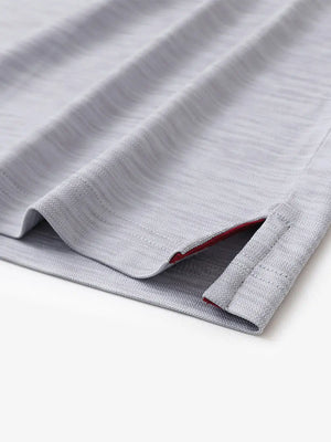 Hem slit detail close-up in FADED DENIM HEATHER Cool Heather Texture Polo