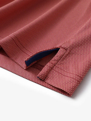 Detailed shot of hem slit design on ORANGE Performance Ananas Jacquard Polo