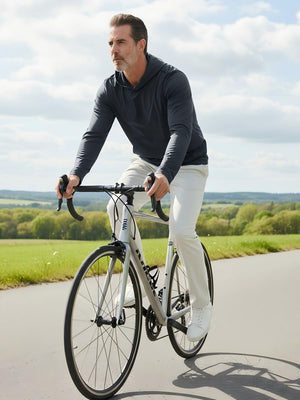 Model riding a bicycle on the road outdoors, wearing dry fit stretchy sweatshirts hoodies in dark grey