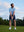 Model in light blue your favorite jacquard polo preparing to tee off, full-body shot